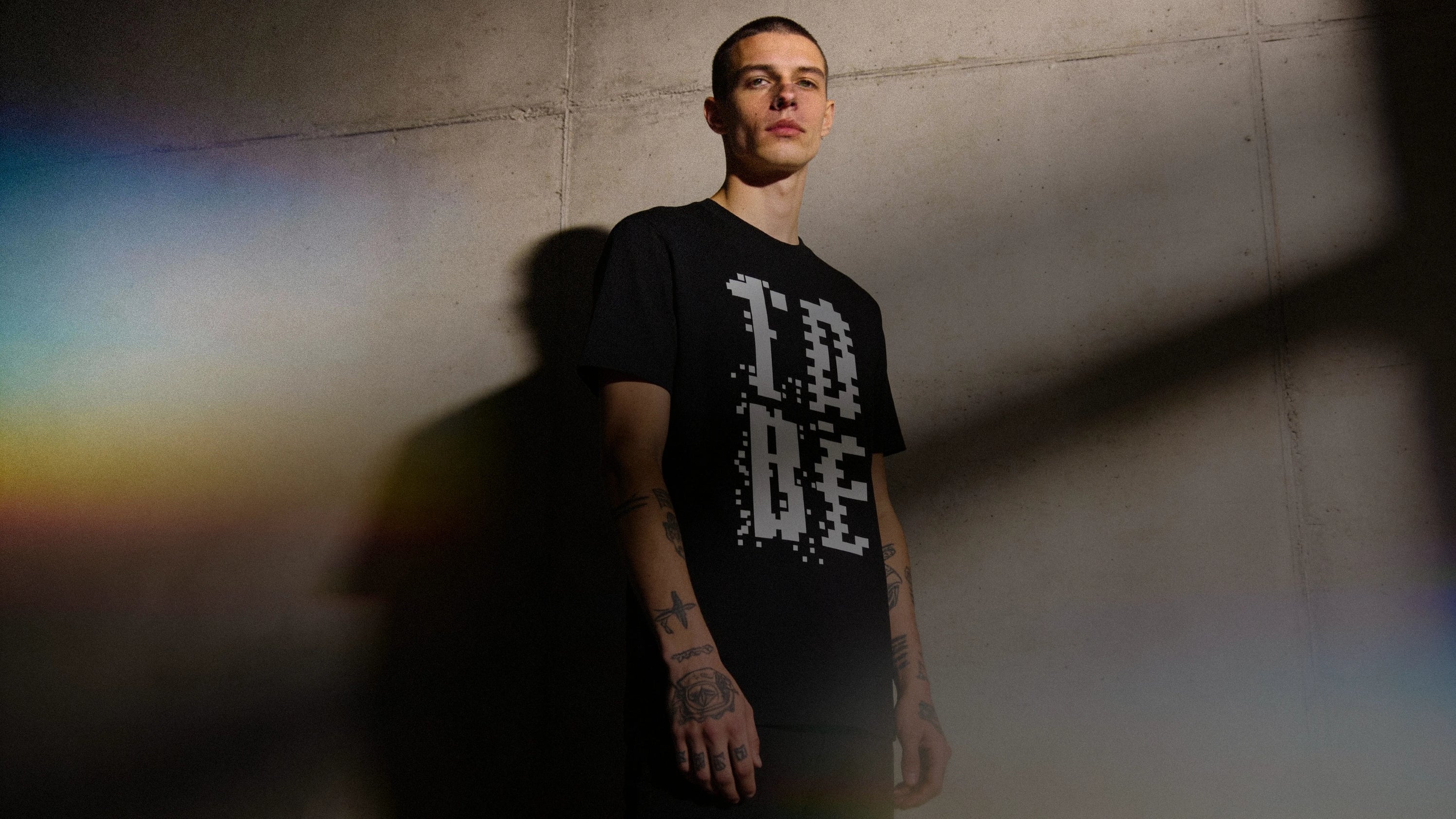 Mężczyzna w czarnej koszulce z nadrukiem „TO BE”